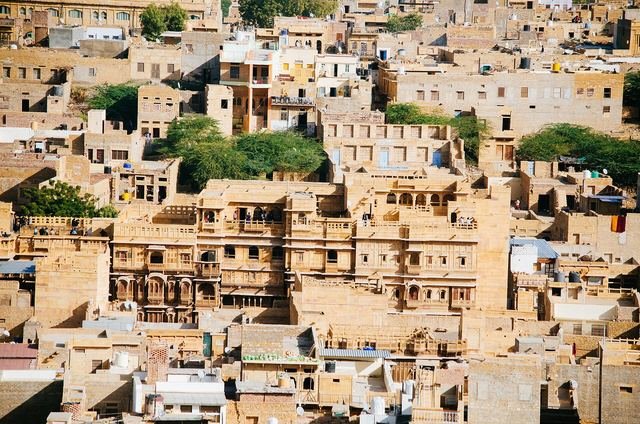Densely packed sandstone houses and rooftops of Jaisalmer's old town seen from above